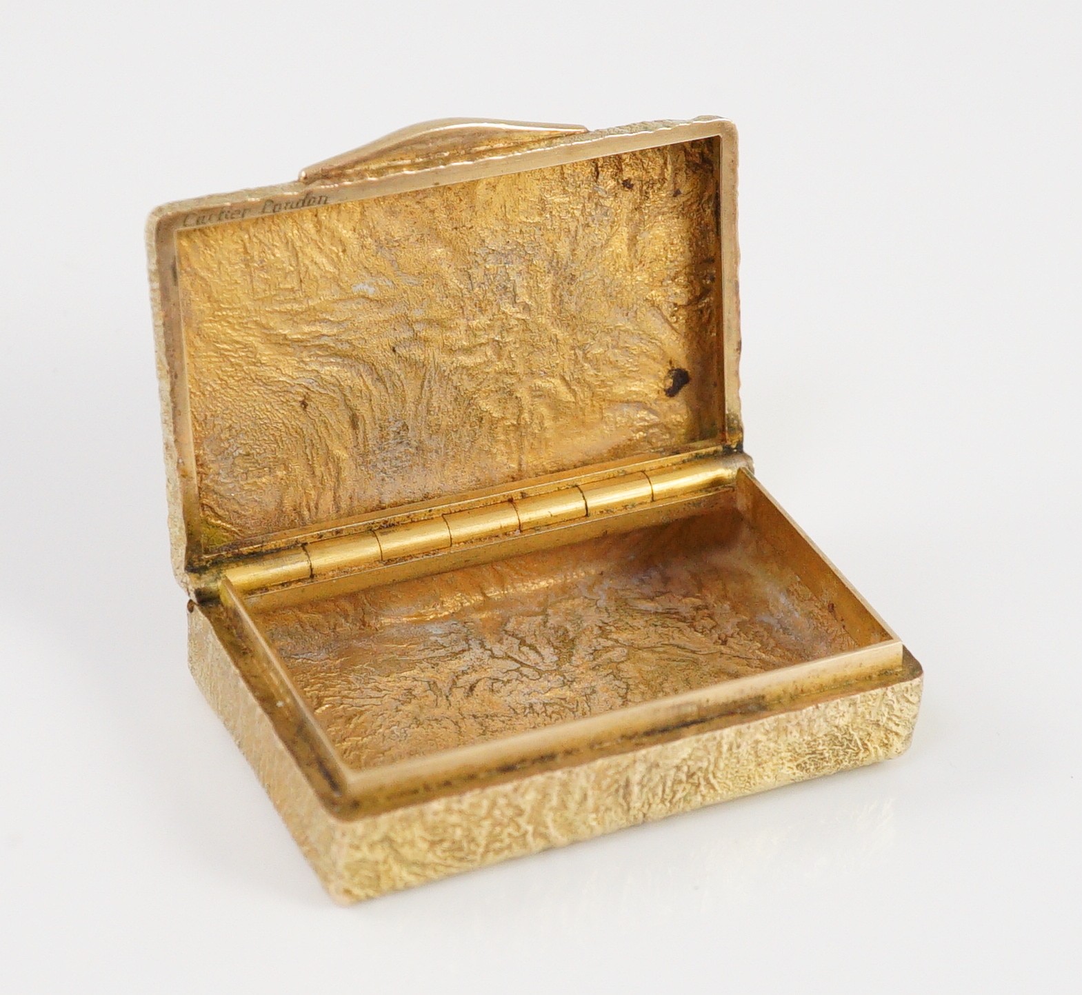 A 1960's 9ct gold Cartier rectangular pill box, with samorodok decoration